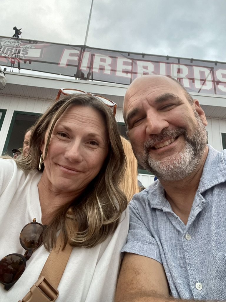 Trish and Brian in the stands at a high school football game