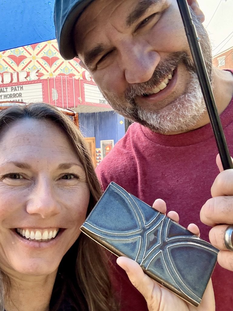 Trish holding a blue Rookwood tile